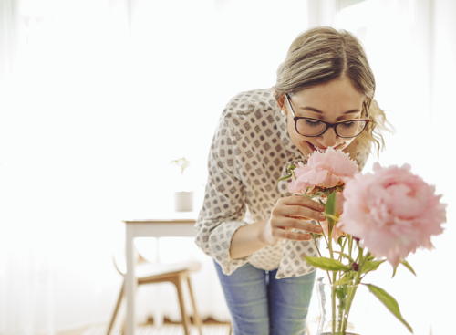 woman smelling flowers